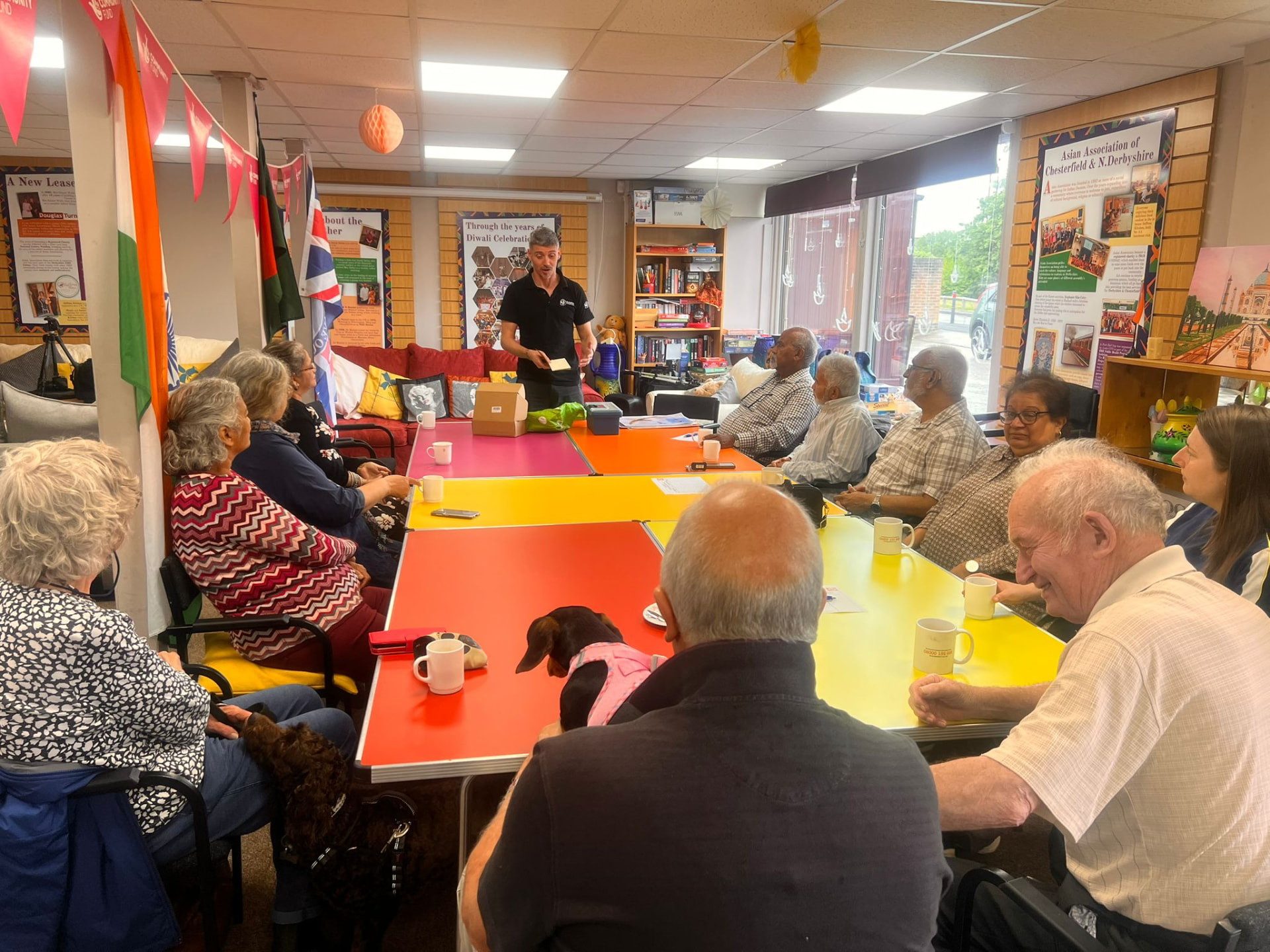 Members of the Asian Association Chesterfield listening to a facilitator standing at the head of the table during a nature connectedness session