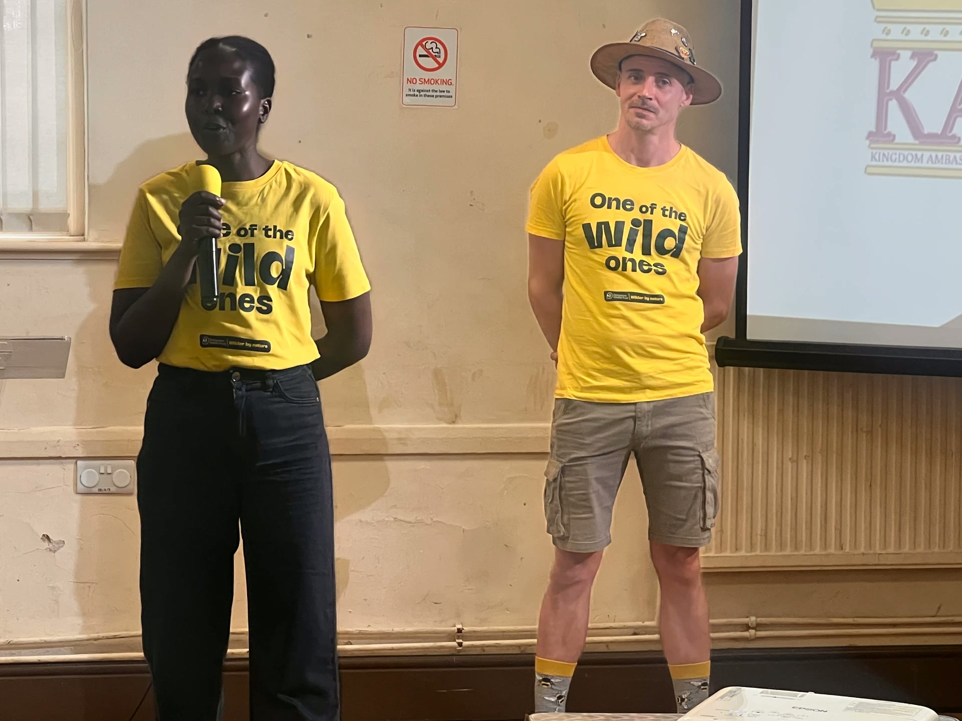 Two facilitators wearing Derbyshire Wildlife Trust One of the wild ones t-shirts presenting to a community audience